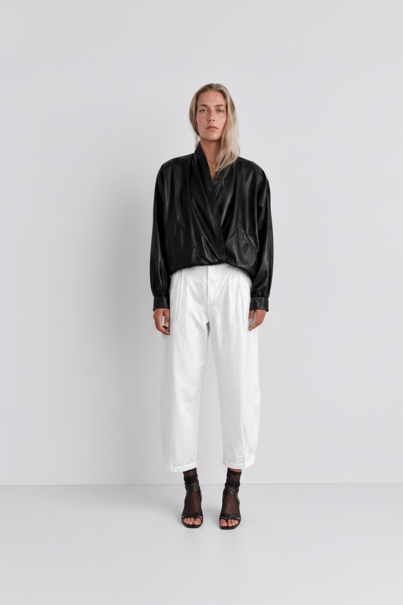 The Sculptural Leather Wrap Jacket — model cool grey tones