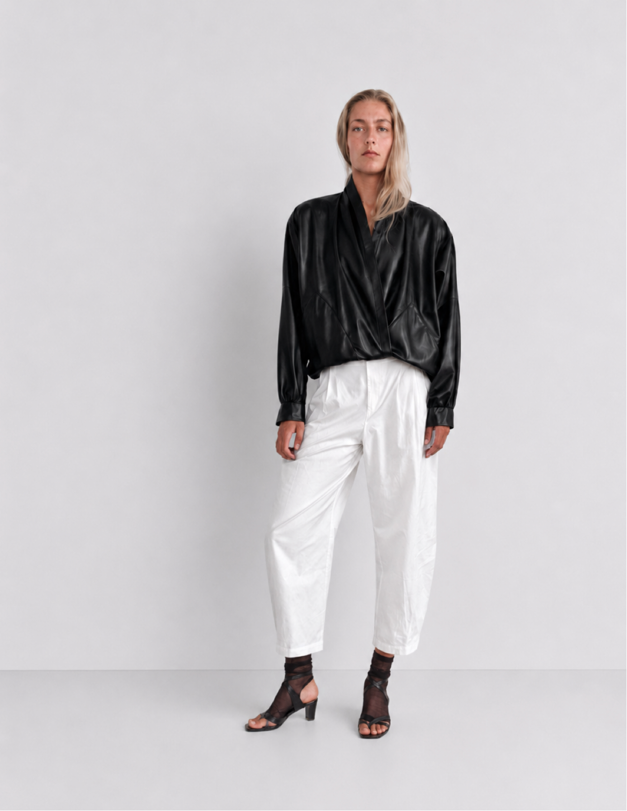 The Sculptural Leather Wrap Jacket — model front view